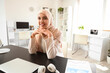 © Pixel-Shot - Beautiful Muslim businesswoman sitting at table in office