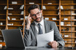 © InsideCreativeHouse - Stressed young businessman having hard issue problem with documents in office. Canceled payment, being fired, receiving negative bad news at workplace. Solving difficult task concept