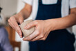 © Zamrznuti tonovi - Close up of female artisan's hands modeling clay mug at ceramics studio