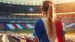 © Marco - beautiful woman from behind with the flag of france inside the stadium
