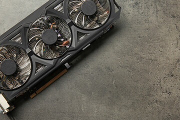 Poster - One computer graphics card on grey textured table, top view. Space for text