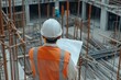 © InfiniteStudio - Engineer with blueprints at a construction site