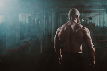 Wall Mural - Caucasian bald man posing in the gym.