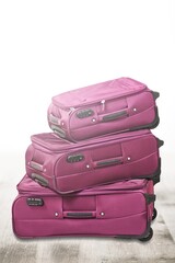 Wall Mural - Stack of colored travel suitcases on background