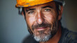 © VISUAL BACKGROUND - A man in a hard hat smiling.