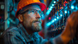 © VISUAL BACKGROUND - A man in glasses and a hard hat is working on a computer.