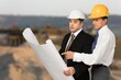 © BillionPhotos.com - Architect and Engineer checking documents at construction site.