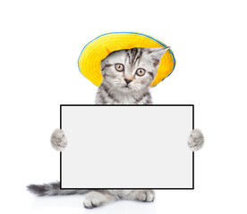 Poster - Tabby kitten wearing summer hat holds blank board. isolated on white background