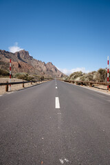 Wall Mural - a highway leading into a mountain area with mountains in the background