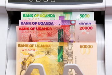 Wall Mural - Ugandan shilling in a counting machine