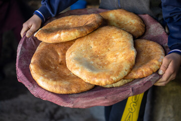 Poster - A person is holding a tray of bread