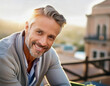 © OceanProd - Portrait of grey hair handsome smiling mature man relaxing outside in city