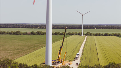 Wall Mural - The European Green Deal for Production of clean green energy. Construction of a wind turbine with crane.