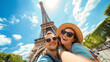 © Jhati - Amidst the hustle and bustle of tourists, a happy couple takes a selfie in front of the Eiffel Tower in Paris, France