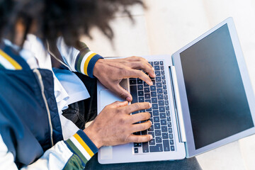 Wall Mural - Close-up of businessman working on laptop outdoors