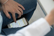 © tunedin - Crop view of student scrolling smartphone trying to copy an exam