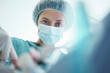 © tunedin - Confident female surgeon operating in intensive care unit at hospital