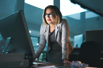 Poster - Woman, business and standing on computer in office for browsing internet, online and research for ideas. Female person, workplace and smile with deadline or overtime, project and reading as hr