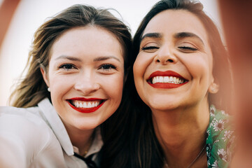 Close-up portrait of smiling beautiful female friends