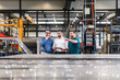 © tunedin - Three men sharing tablet on factory shop floor