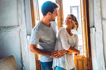 Poster - Affectionate young couple dancing in living room at home