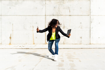 Wall Mural - Woman holding smartphone and tablet, screaming and taking a selfie