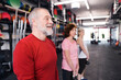 © tunedin - Group of fit seniors in gym working out with kettlebells