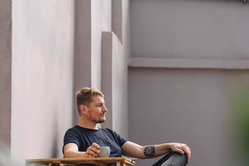 Canvas Print - Man having a break outside a building