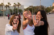 © tunedin - Spain, Barcelona, three happy young women showing Rock And Roll Sign