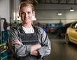 © OceanProd - Car woman professional mechanic work mechanic in the workshop posing arms crossed