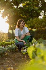 Wall Mural - Woman working in her vegetable garden