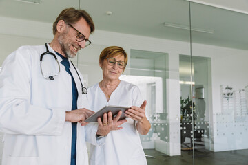 Wall Mural - Doctor and assistant using tablet in medical practice