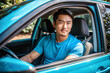 © KingKongThePitbull - Handsome asian man in a T-shirt sits behind the wheel in a car