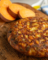 Wall Mural - Spanish omelette with sweet potato, onion and egg. Traditional tapa of Spanish gastronomy.