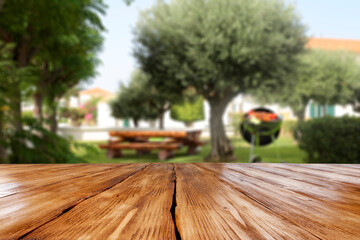 Poster - Wooden desk of free space and grill party in garden 