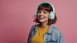 © muqadas - Portrait of good mood adorable woman with bob hair wear colorful top touch headphones enjoy music isolated on pink color background