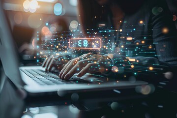 Person typing on laptop under glowing screen