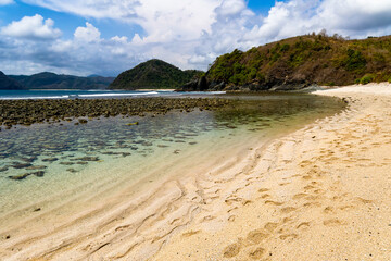 Wall Mural - Rocky, tropical beach surrounded by blue ocean (Semeti Beach, Lombok)