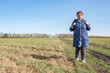 © Zuev Ali - An elderly woman walks through a field.