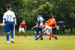 © matimix - Football Teams Compete in Youth Soccer League. Children Play Soccer Match Outdoor. Group Of Teenage Soccer Players Kicking Soccer Ball on Grass Pitch