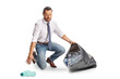© Ljupco Smokovski - Businessman kneeling and collecting bottles in a plastic bag