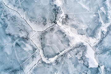 Wall Mural - Aerial view of a frozen lake, capturing the intricate cracks and patterns formed in the ice. Emphasize the clean, sharp lines and the subtle variations in the ice texture. 