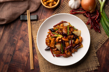 Wall Mural - Stir fried crispy chicken with roasted chili paste and cashew nuts in white plate.Top view