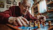 © Julia Jones - Senior Citizens Day. Elderly man concentrating on a chess game indoors.
