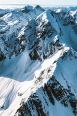 Wall Mural - Aerial view of snowy mountain peaks, highlighting the sharp contrasts between the white snow and the dark rocky outcrops. Focus on the clean lines and dramatic shadows.