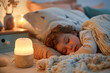 © Kowit - A child is sleeping on a bed with a lamp next to them