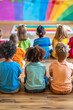 © ivlianna - Classroom activity teaching children about diversity and promoting acceptance of others.Children sitting in front of a rainbow wall on the floor
