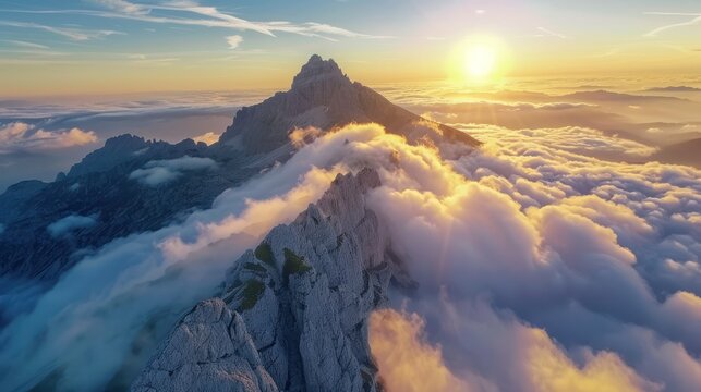 Beautiful landscape of sun in behind a mountain covered in white clouds sky