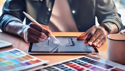 Graphic designer working on a digital tablet, close up on the stylus and screen