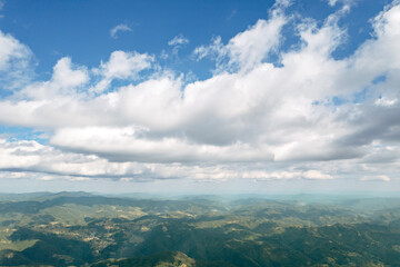 Poster - Moving white clouds blue sky scenic aerial view through summer. Drone slide turn flies forward high in blue sky through fluffy clouds on the panorama